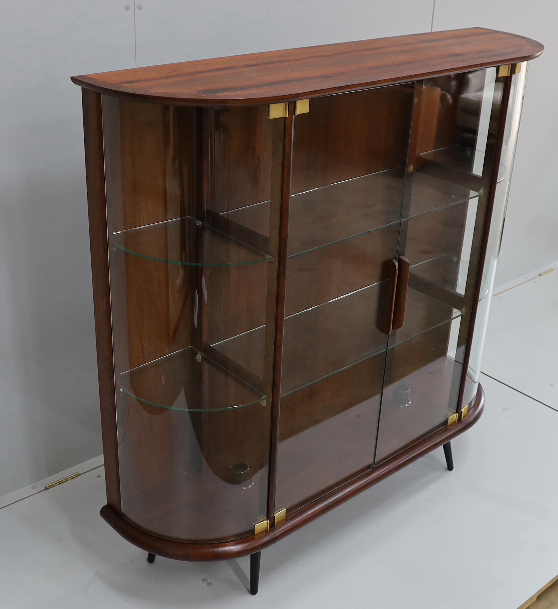 A mid century Indian rosewood glazed display cabinet with lighting, width 133cm, depth 36cm, height 130cm